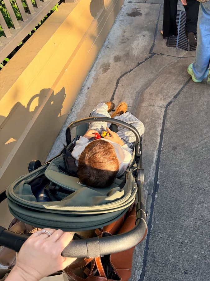 Toddler asleep in a Bugaboo stroller, reclined flat